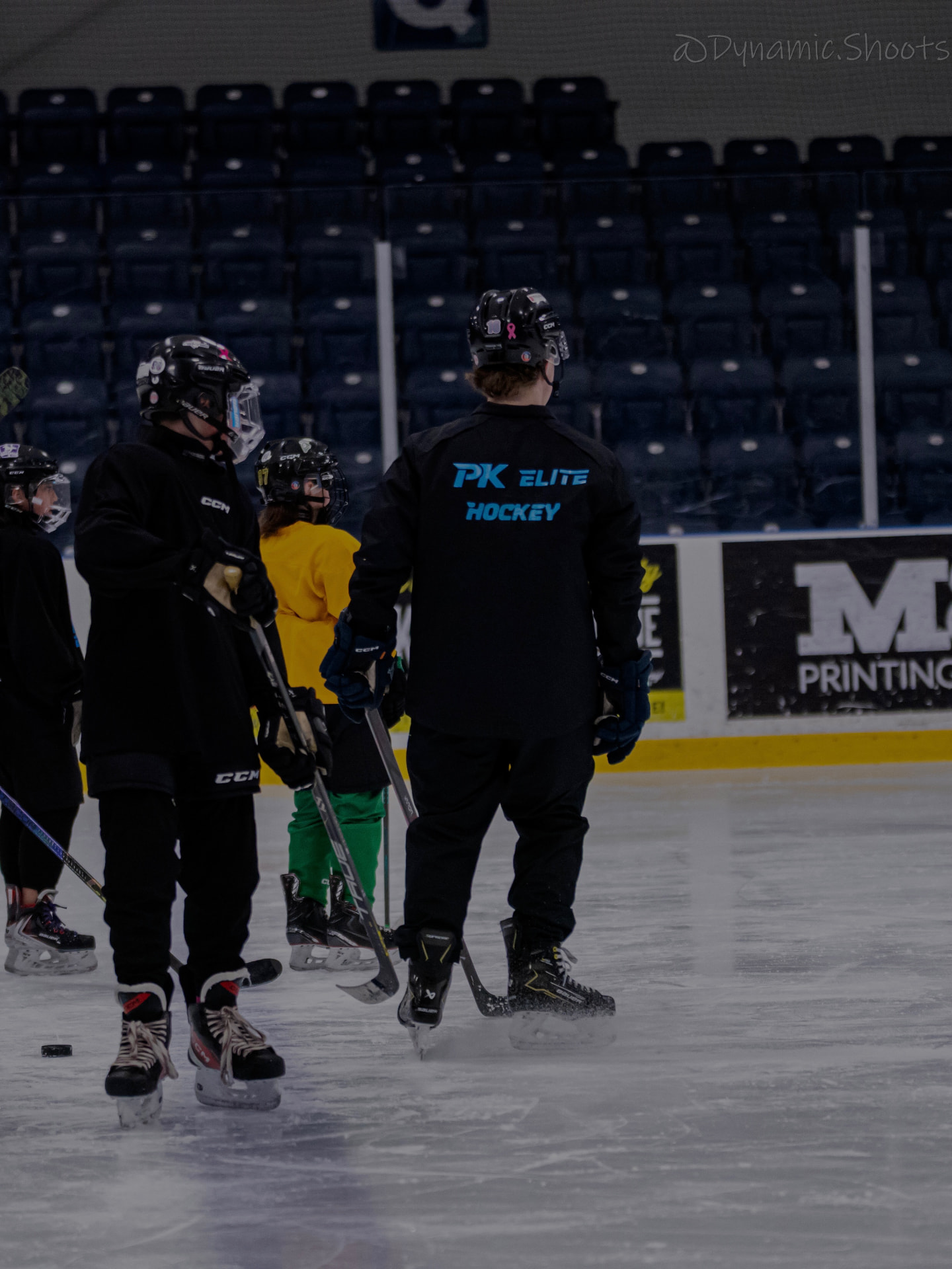 Coach Peter in PK Elite Hockey gear leading young players during an on-ice development skate